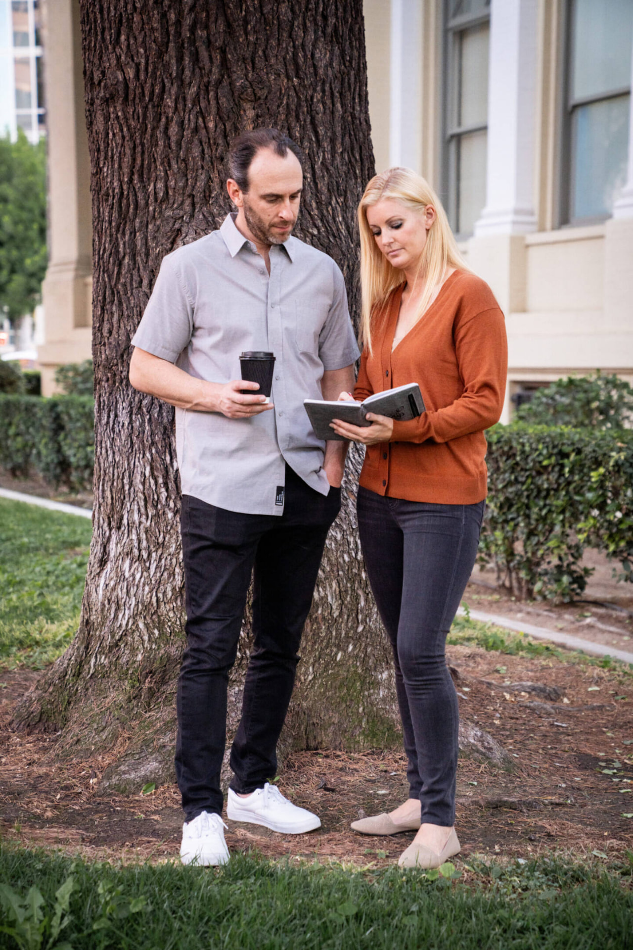 Two Stance Commercial Real Estate principals reviewing notes outside an office building