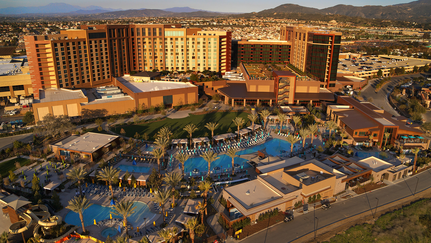 Aerial view of Pechanga Resort Casino towers, pools, and the surrounding valley at golden hour