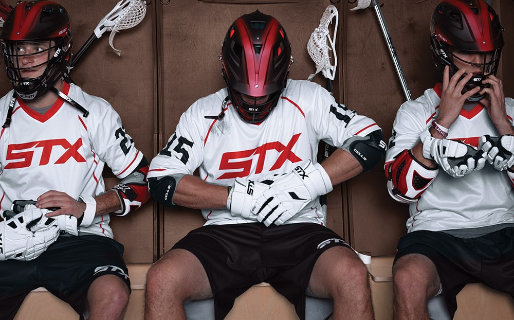 Lacrosse players preparing in a locker room before a match