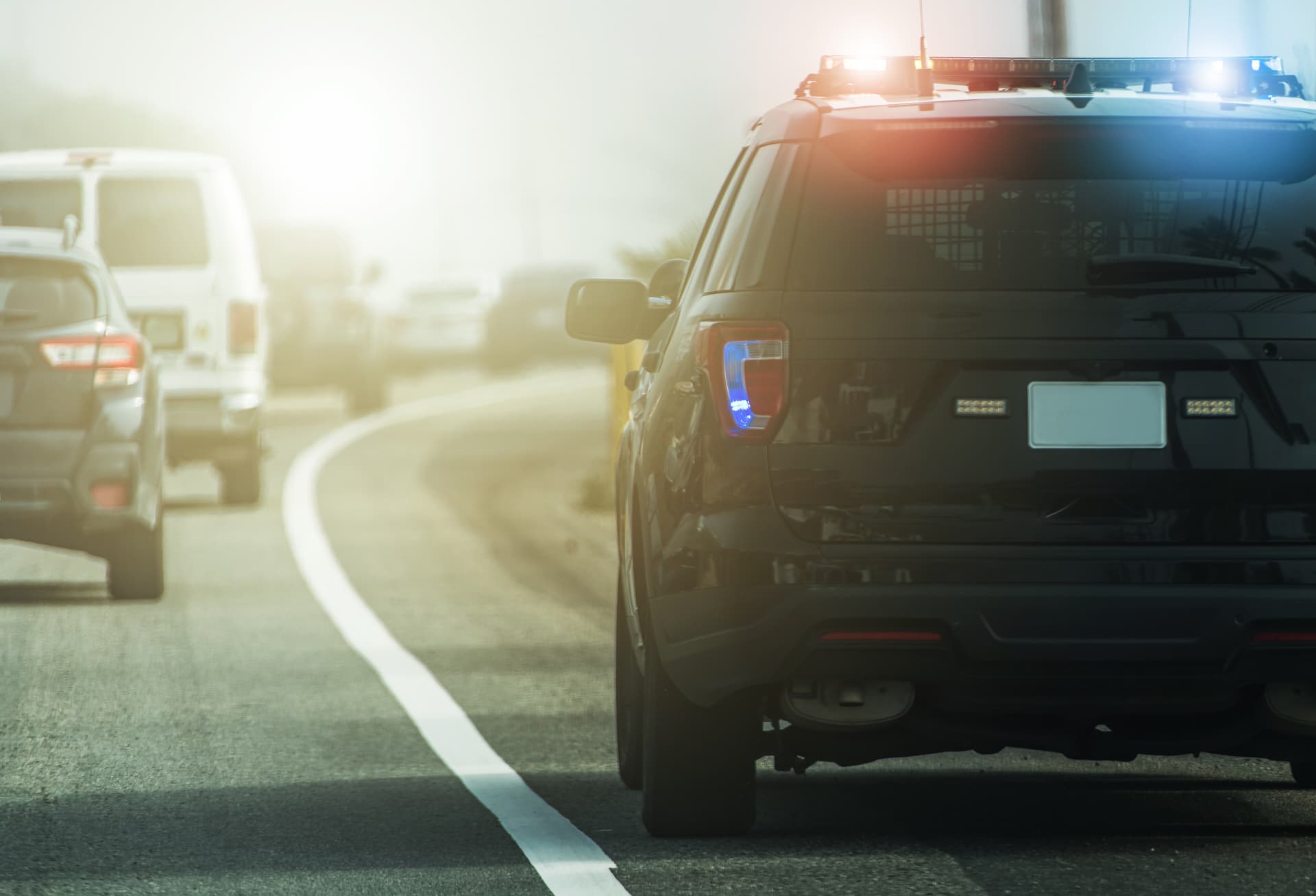 Public safety patrol vehicle with lights active on a highway