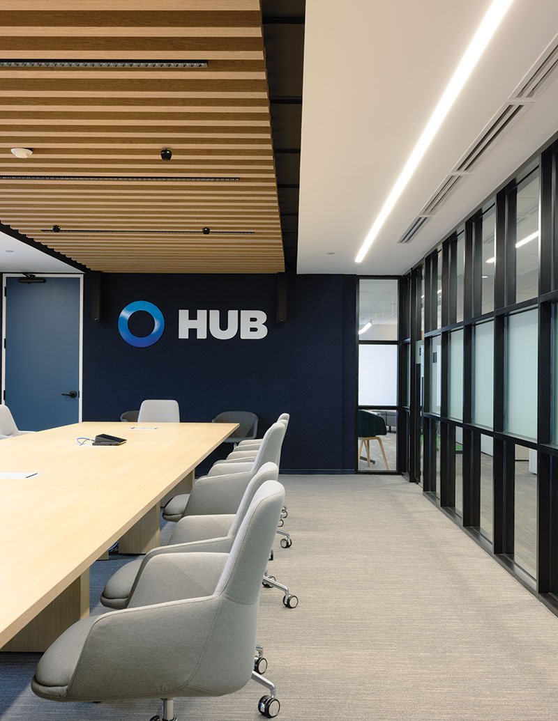 Meeting room with the HUB International logo on a dark accent wall