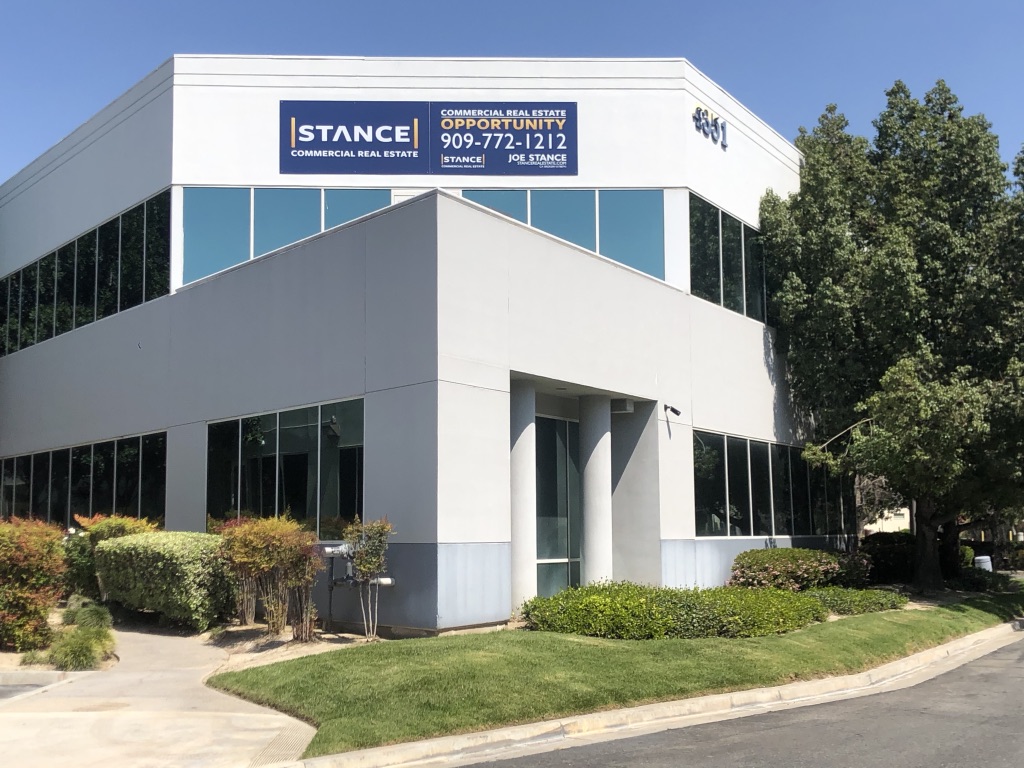 Stance Commercial Real Estate signage on a two-story office building