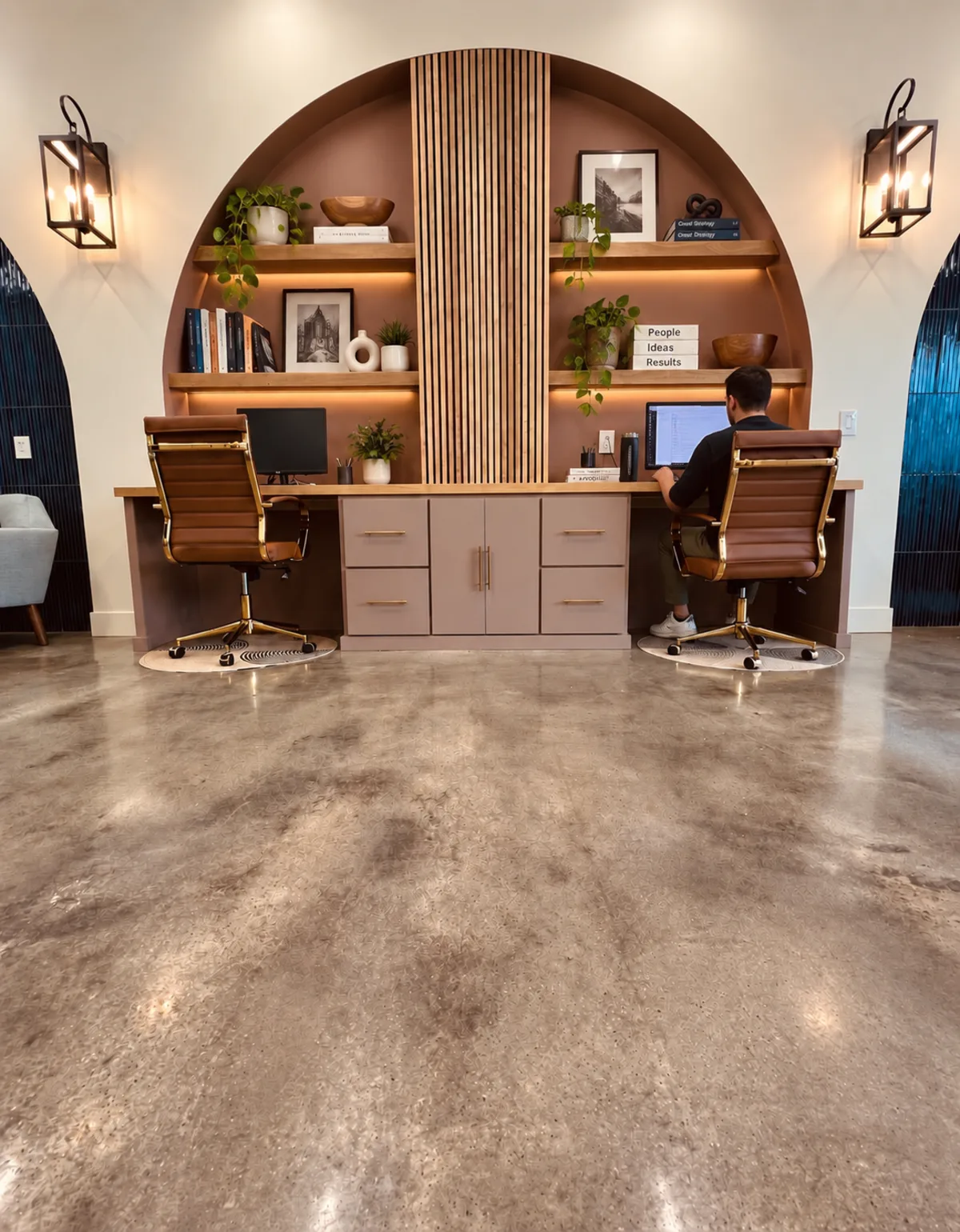 An arched built-in workstation alcove in the Raincross office with a team member at a desk